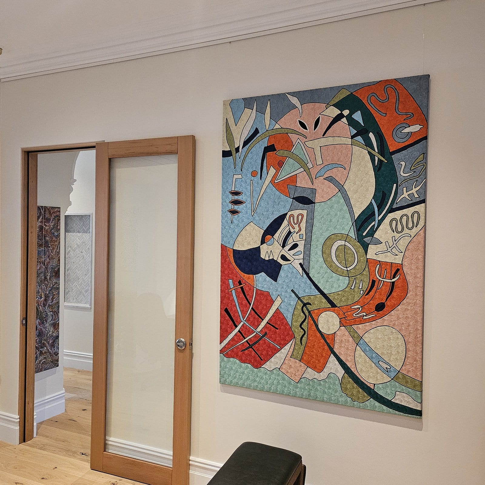 ArtiTeq Click Rail Hallway Feature | Hang Logic Colourful abstract canvas hung on clear perlon wires from an ArtiTeq ClickโฏRail picture rail in a hallway