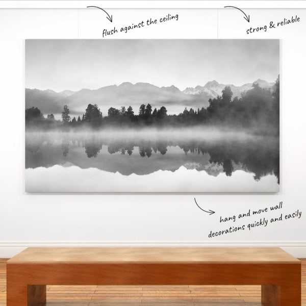 Large black‑and‑white canvas hung on ArtiTeq Click Rail Pro picture rail flush to ceiling, shown in modern gallery setting