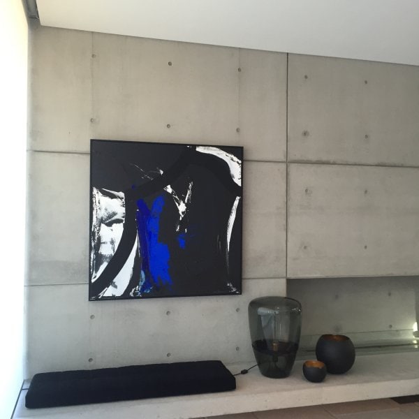 Abstract artwork on off‑form concrete wall hung from hidden ArtiTeq Shadowline Masonry picture rail, fine shadow line