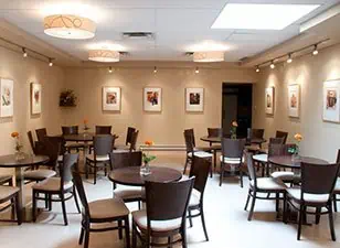 Dining area in residential care home enhanced with artwork using Artiteq's Click Rail system, from Hang Logic.