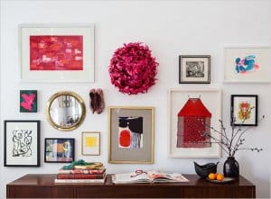 Many different pictures hung on a white wall