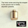 Close-up of tightened rail stopper for slanted walls, securing hanging wires. Available at Hang Logic