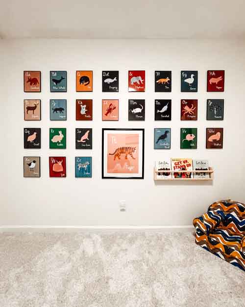 Educational posters of animals and alphabet letters displayed on a wall in a children's room.