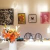 Dining wall with four framed artworks hung on clear Solid Slider perlon wires from a white ArtiTeq picture rail, supplied by Hang Logic.