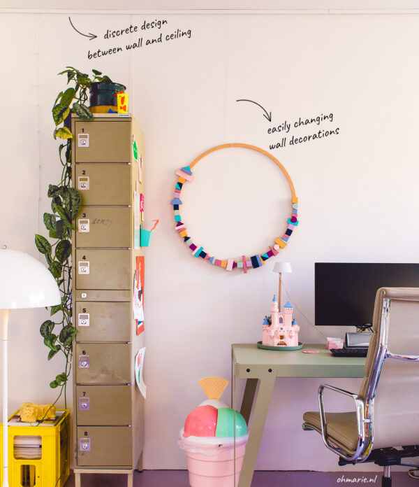 Up Rail - wall-friendly ceiling picture rail Up Rail ceiling-fixed picture rail in a home office, keeping walls pristine while allowing easy, flexible hanging.