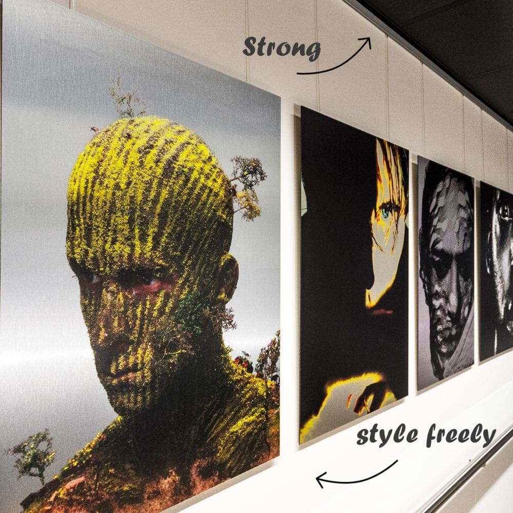 ArtiTeq Click Rail Pro Picture Rail Large portrait artworks hanging on wires from an ArtiTeq Click Rail Pro picture rail mounted high on a gallery wall.