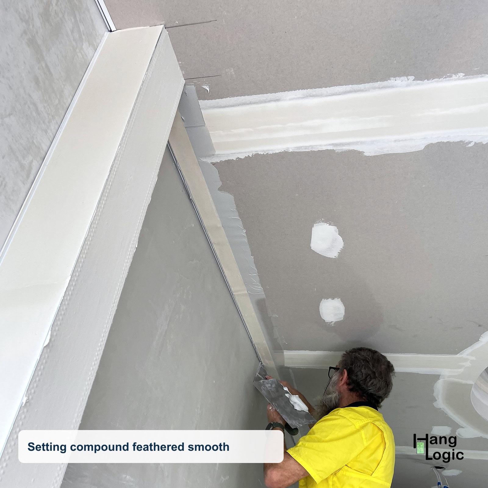 Plasterer finishing the Shadowline Masonry wall and ceiling junction